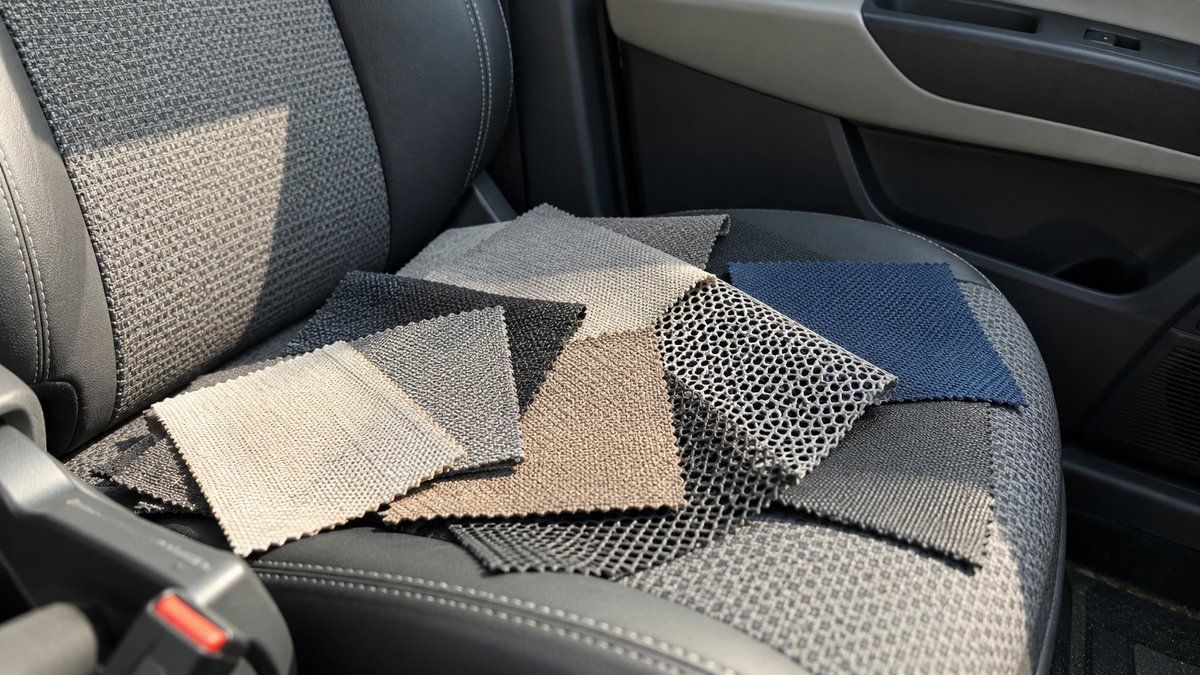 Fabric, mesh and synthetic upholstery samples on a car seat