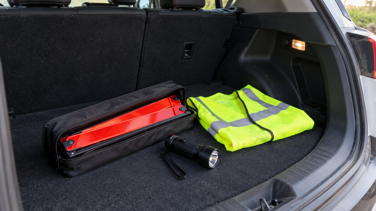Warning triangle case, reflective vest and torch packed in a boot